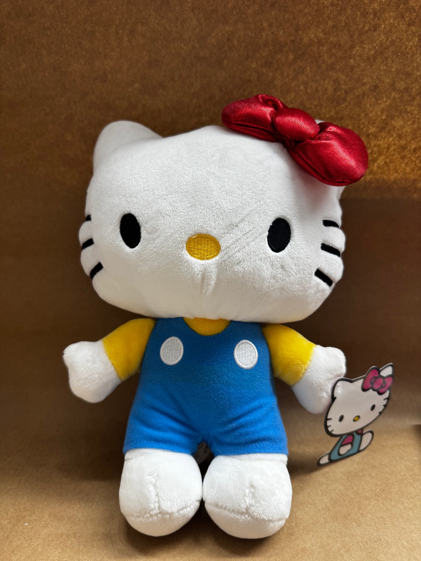 New~ Sanrio Hello Kitty 10-inch plush doll wearing a yellow shirt and blue overalls